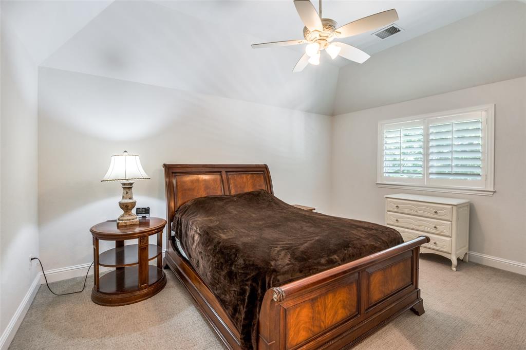 10482 Tobias Lane Frisco, TX 75033 - Photo 21 of 40 a bedroom with a bed and a table in it