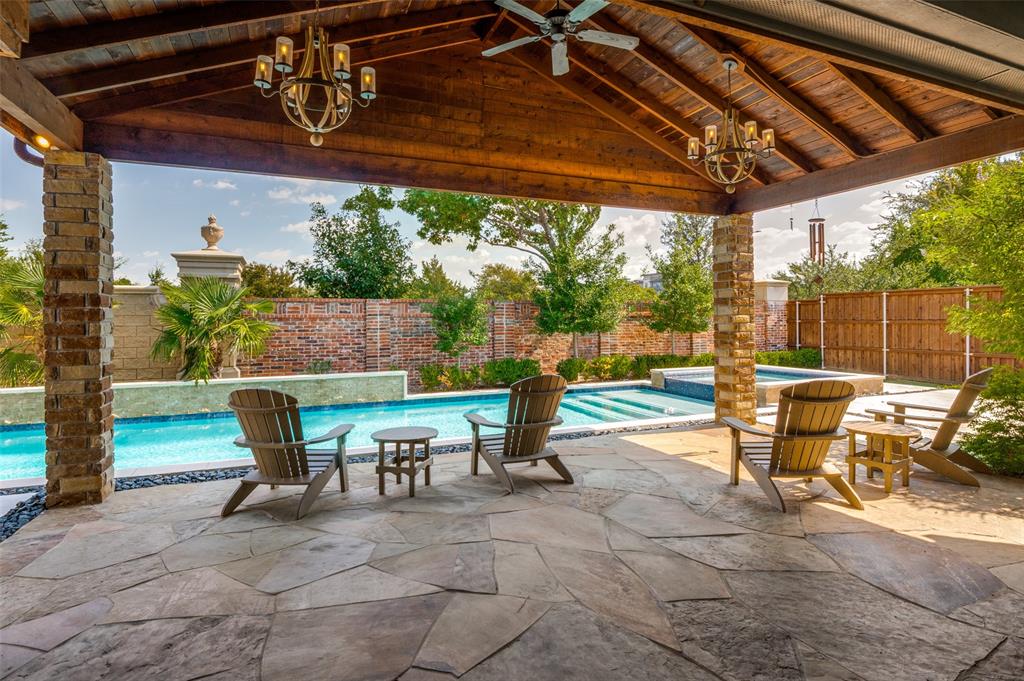 10482 Tobias Lane Frisco, TX 75033 - Photo 34 of 40 a view of a patio with table and chairs potted plants with floor to ceiling window and wooden fence