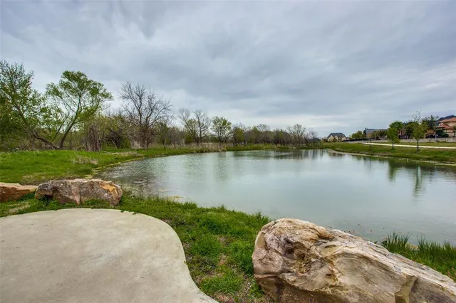a view of a lake with houses in the back