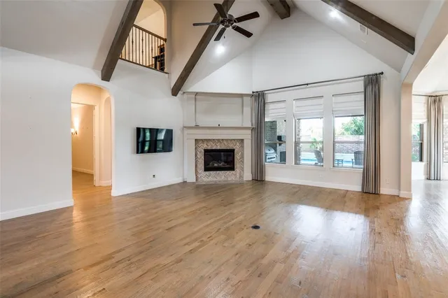 a view of empty room with wooden floor and fireplace