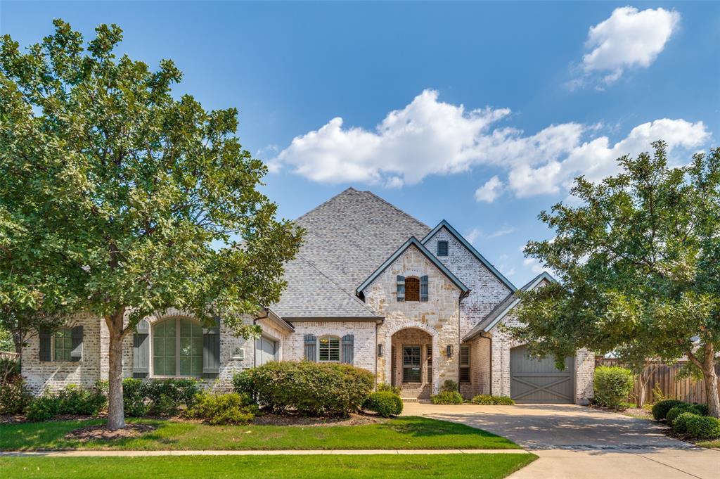 10482 Tobias Lane Frisco, TX 75033 - Photo 7 of 40 a view of a white house with a yard and palm trees
