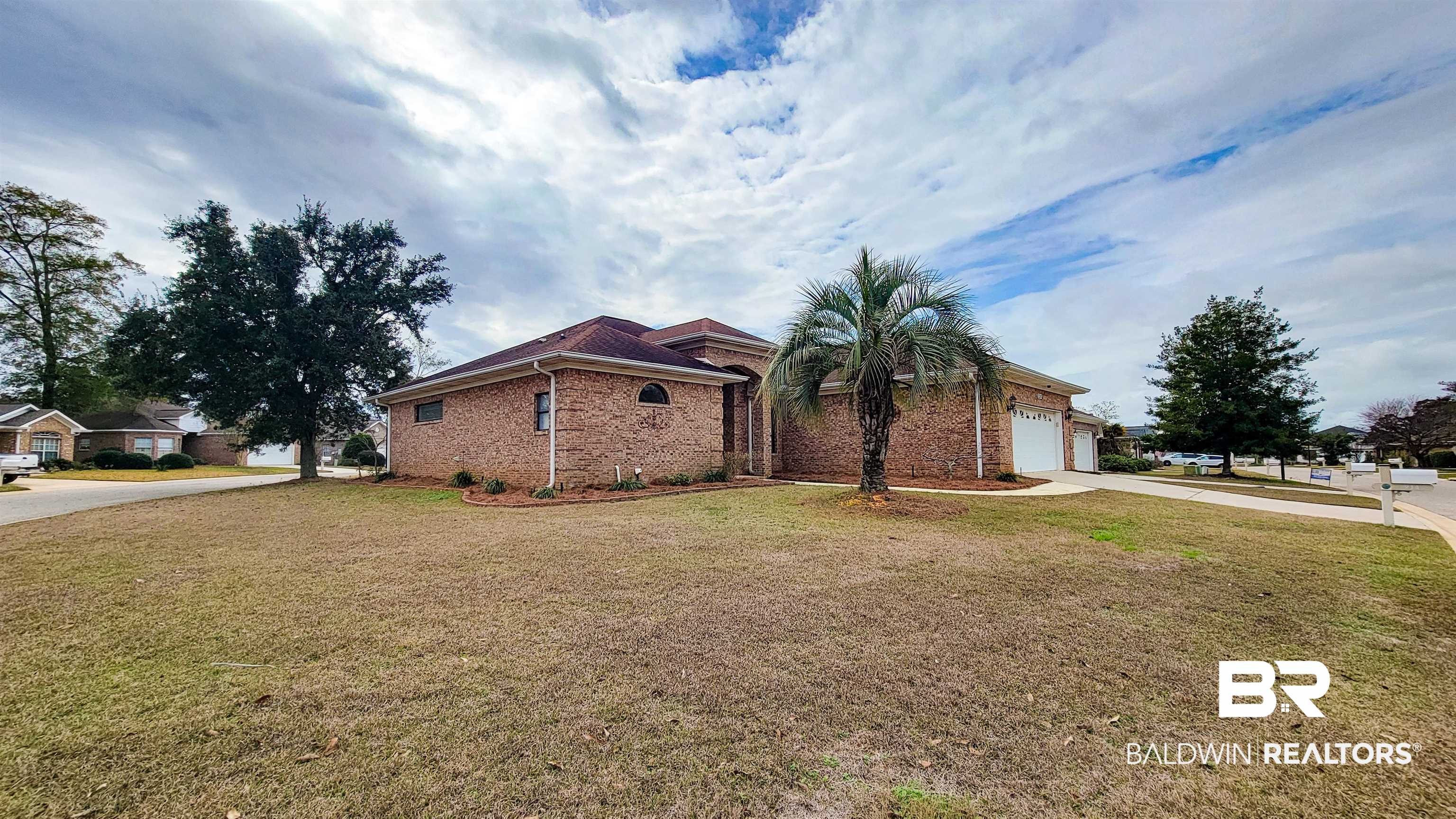 214 Hemingway Loop Foley, AL 36535 - Photo 3 of 67 View of side of home with a lawn, driveway, brick siding, and a garage