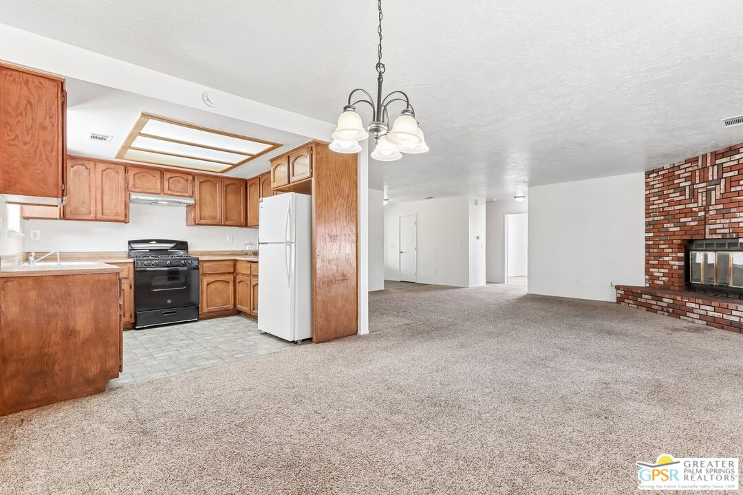 13819 Rivers Edge Road Helendale, CA 92342 - Photo 10 of 31 a view of a kitchen with a stove cabinets and a kitchen