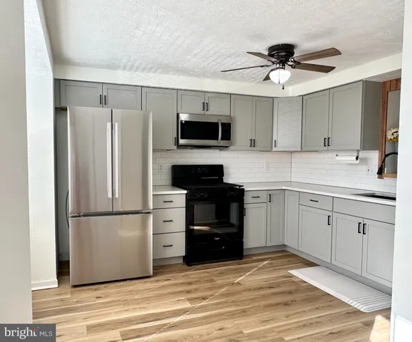 a kitchen with a refrigerator and a sink