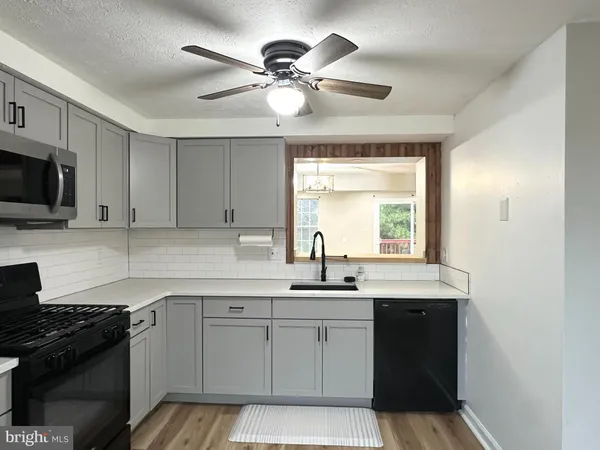 a kitchen with a sink stove and microwave