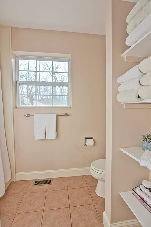 14 Robbins Road Foxboro, MA 02035 - Photo 33 of 42 a bathroom with a granite countertop sink a toilet and a window