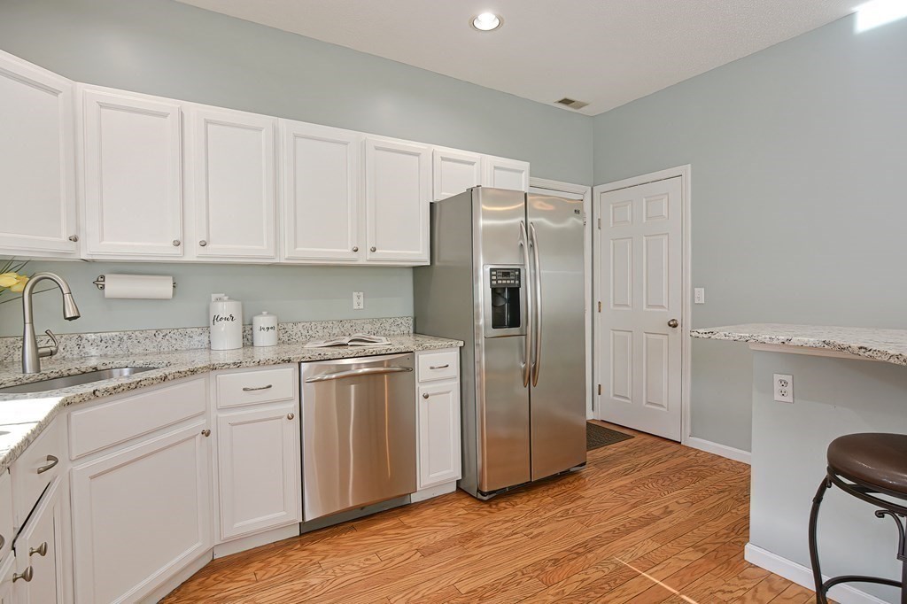 14 Robbins Road Foxboro, MA 02035 - Photo 5 of 42 a kitchen with stainless steel appliances granite countertop a refrigerator sink and white cabinets