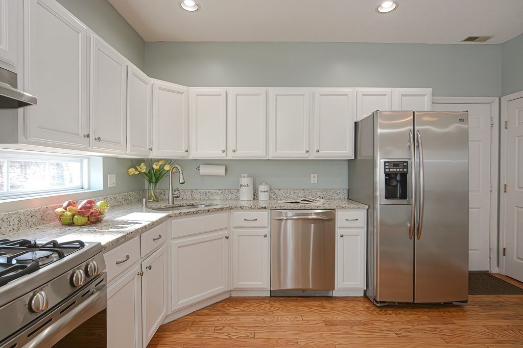 14 Robbins Road Foxboro, MA 02035 - Photo 6 of 42 a kitchen with stainless steel appliances granite countertop a refrigerator a sink a stove and white cabinets