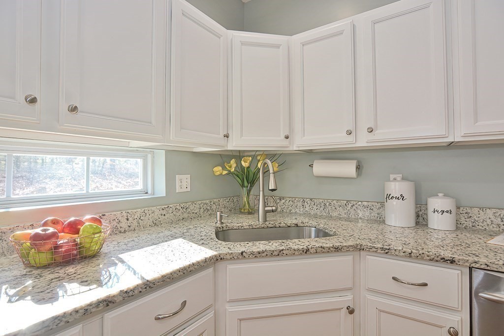 14 Robbins Road Foxboro, MA 02035 - Photo 7 of 42 a kitchen with granite countertop white cabinets white appliances and sink
