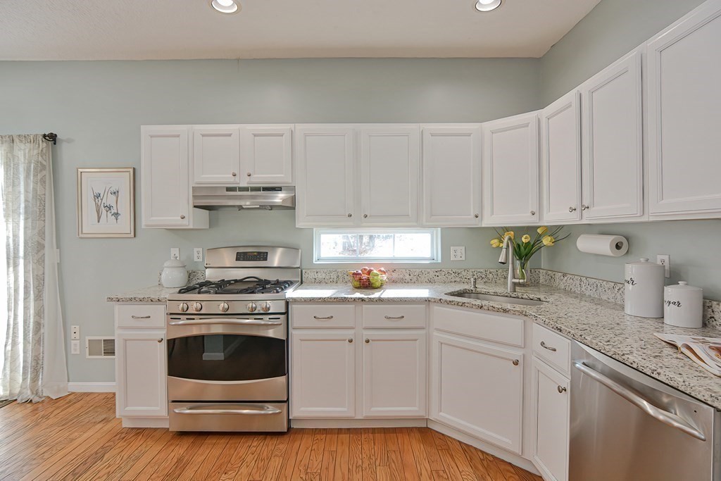 14 Robbins Road Foxboro, MA 02035 - Photo 8 of 42 a kitchen with cabinets stainless steel appliances a sink and wooden floor