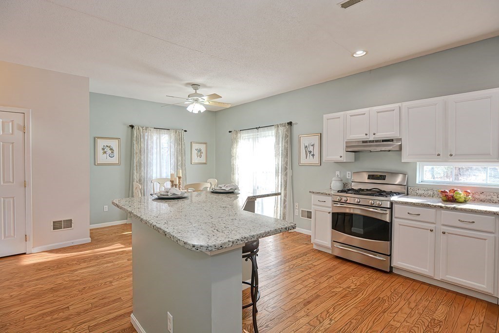 14 Robbins Road Foxboro, MA 02035 - Photo 9 of 42 a kitchen with granite countertop a sink cabinets stainless steel appliances and wooden floor