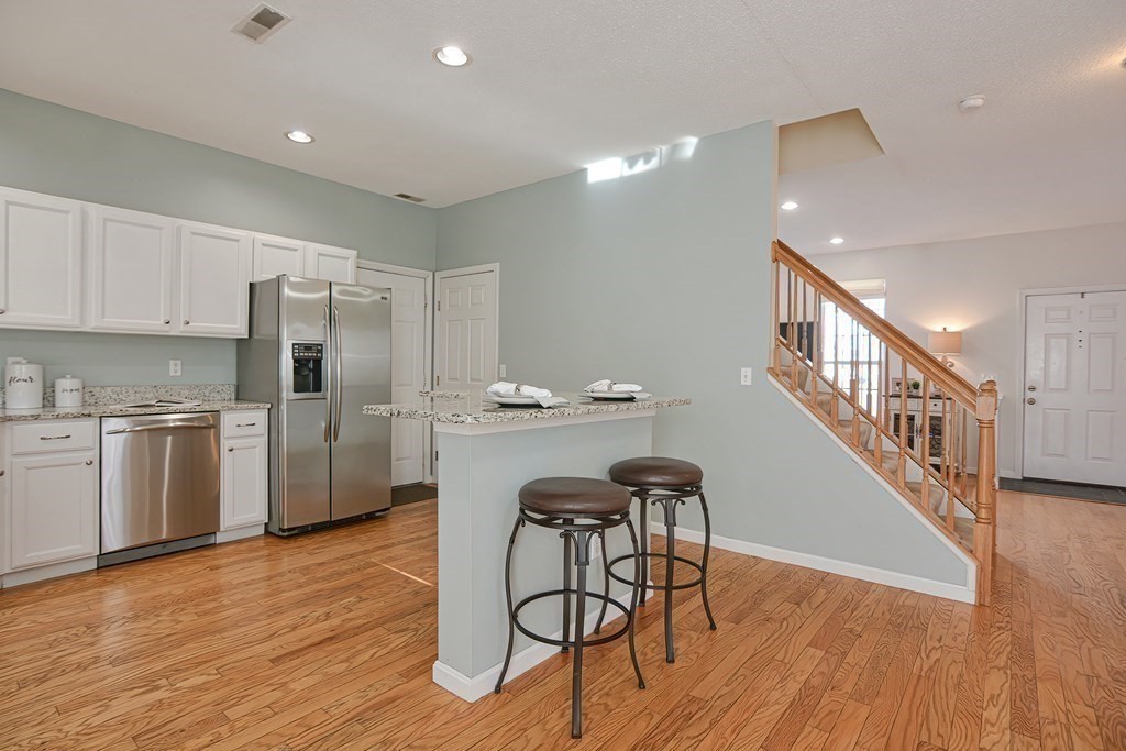 14 Robbins Road Foxboro, MA 02035 - Photo 10 of 42 a kitchen with granite countertop cabinets stainless steel appliances and wooden floor