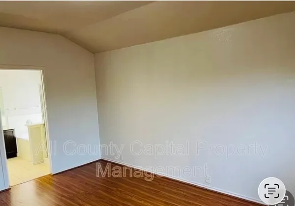 a view of a room with wooden floor