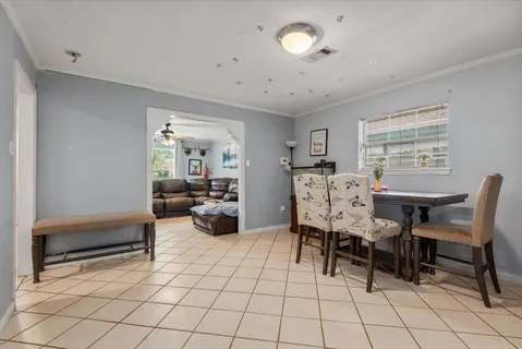 a kitchen with stainless steel appliances granite countertop a stove a sink dishwasher and a refrigerator with wooden cabinets