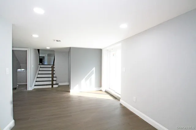 a view of an empty room with a staircase