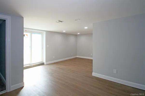 a view of an empty room with a staircase