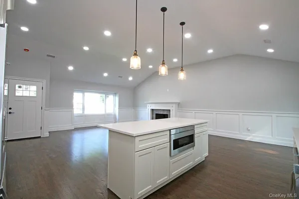 a large white kitchen with a large window