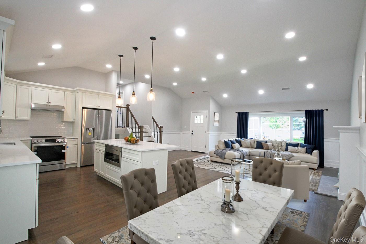 16 Eleanor Road Plainview, NY 11803 - Photo 3 of 27 Dining space featuring lofted ceiling, wainscoting, recessed lighting, and hardwood floors (virtually staged)