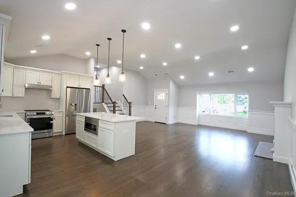 a large kitchen with a table and chairs
