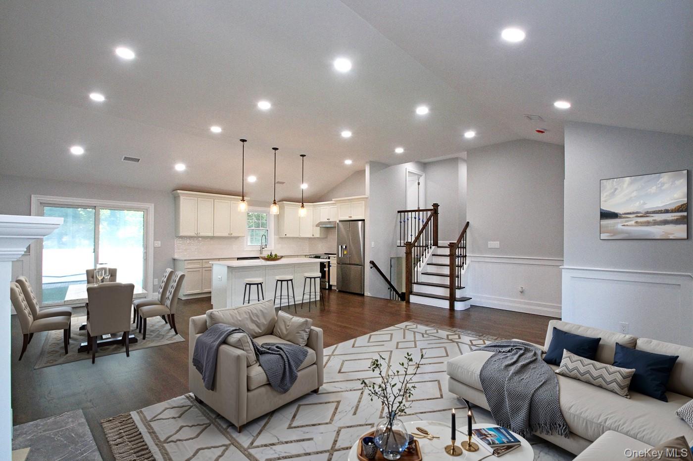16 Eleanor Road Plainview, NY 11803 - Photo 5 of 27 Living room with vaulted ceiling, dark wood finished floors, recessed lighting, and stairs to bedrooms (virtually staged)