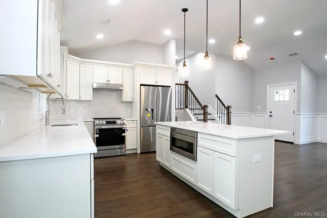 a kitchen with a stove a sink and a refrigerator