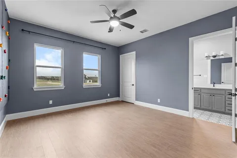a view of a hallway with wooden floor and workspace