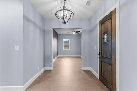 an empty room with windows and fireplace