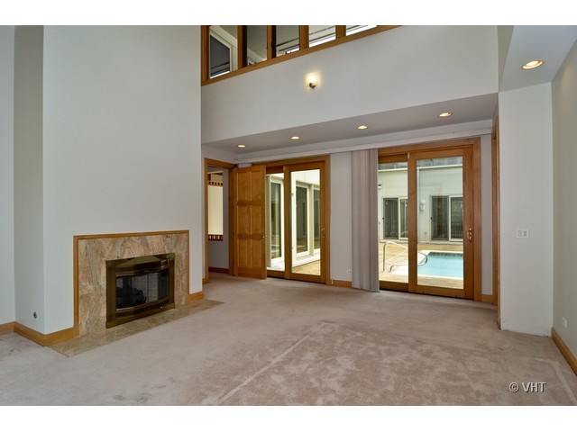 115 Dickens Road Northfield, IL 60093 - Photo 12 of 25 a view of an empty room with a fireplace and a window