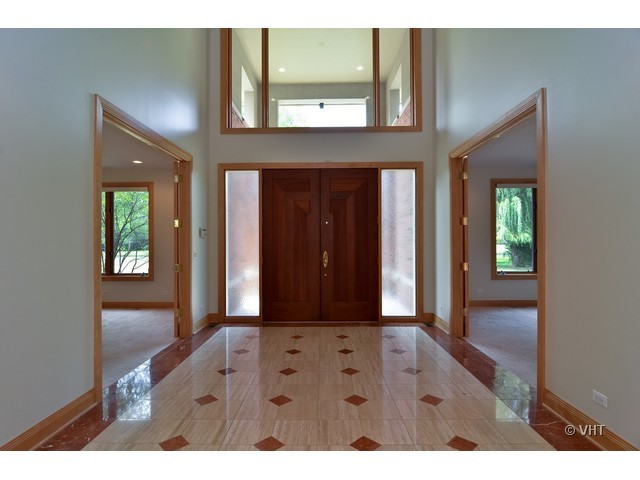115 Dickens Road Northfield, IL 60093 - Photo 2 of 25 a view of hallway with a mirror and a vanity