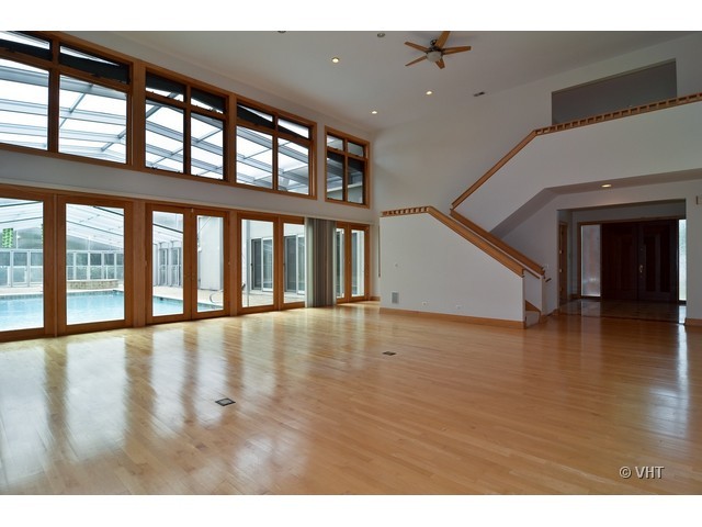 115 Dickens Road Northfield, IL 60093 - Photo 3 of 25 wooden floor in an empty room with a window