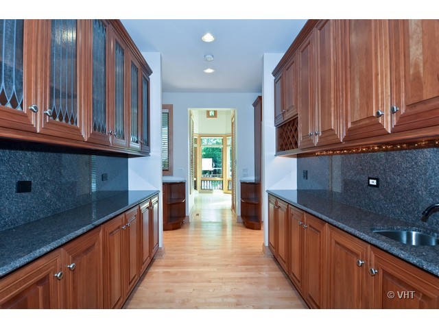 115 Dickens Road Northfield, IL 60093 - Photo 6 of 25 a kitchen with stainless steel appliances wooden cabinets and a sink