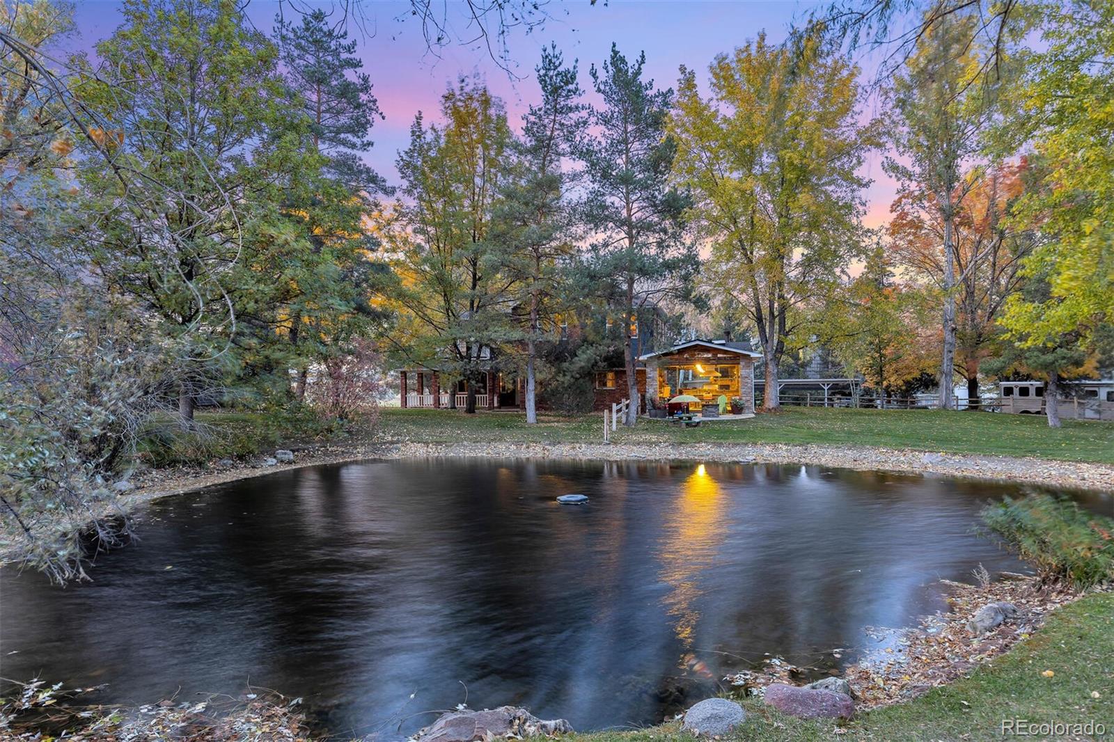 a view of pool with outdoor seating and lake