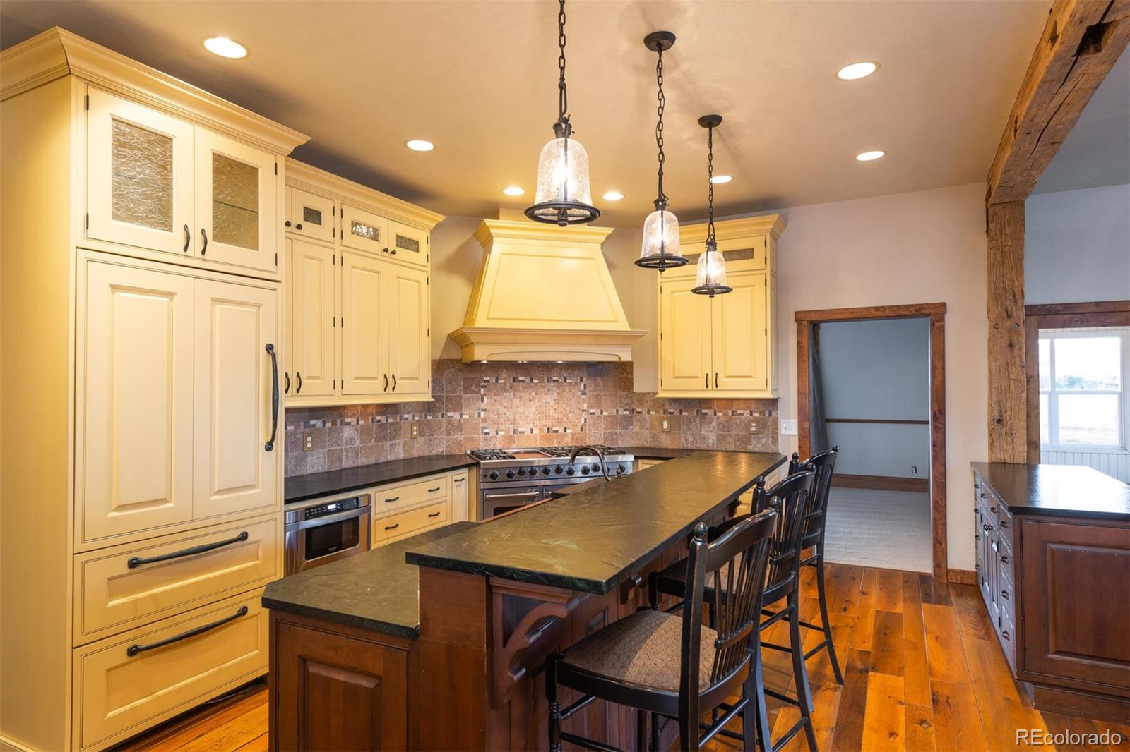 9905 Isabelle Road Lafayette, CO 80026 - Photo 22 of 38 a kitchen with stainless steel appliances granite countertop a stove a sink and a refrigerator