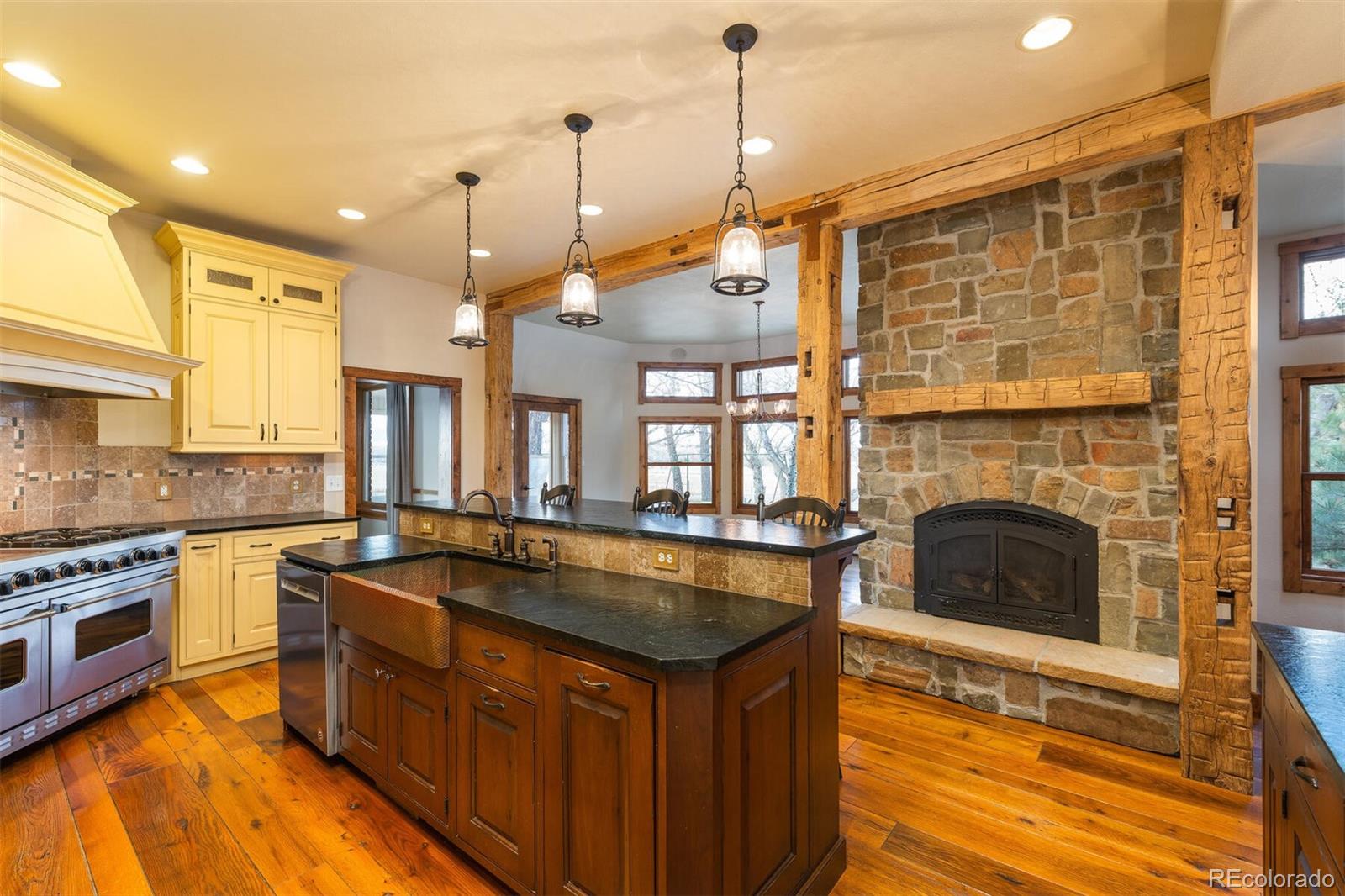 9905 Isabelle Road Lafayette, CO 80026 - Photo 24 of 38 a kitchen with stainless steel appliances granite countertop a stove a sink and a wooden floors