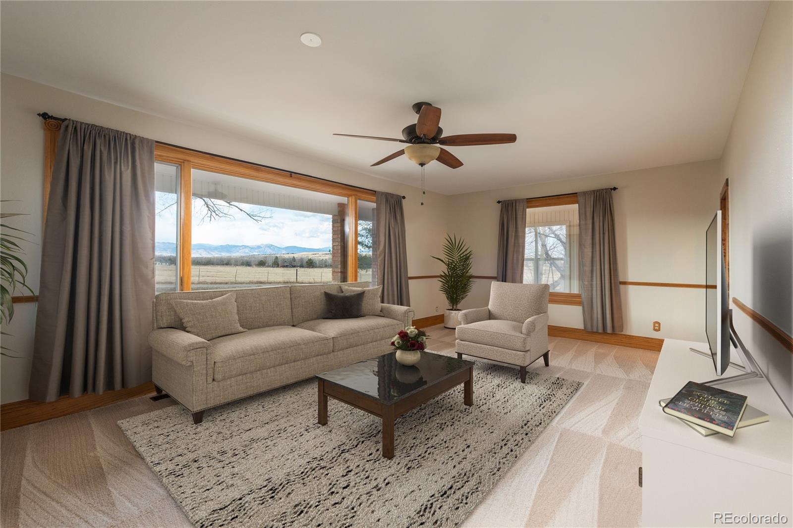 9905 Isabelle Road Lafayette, CO 80026 - Photo 27 of 38 a living room with furniture and a large window