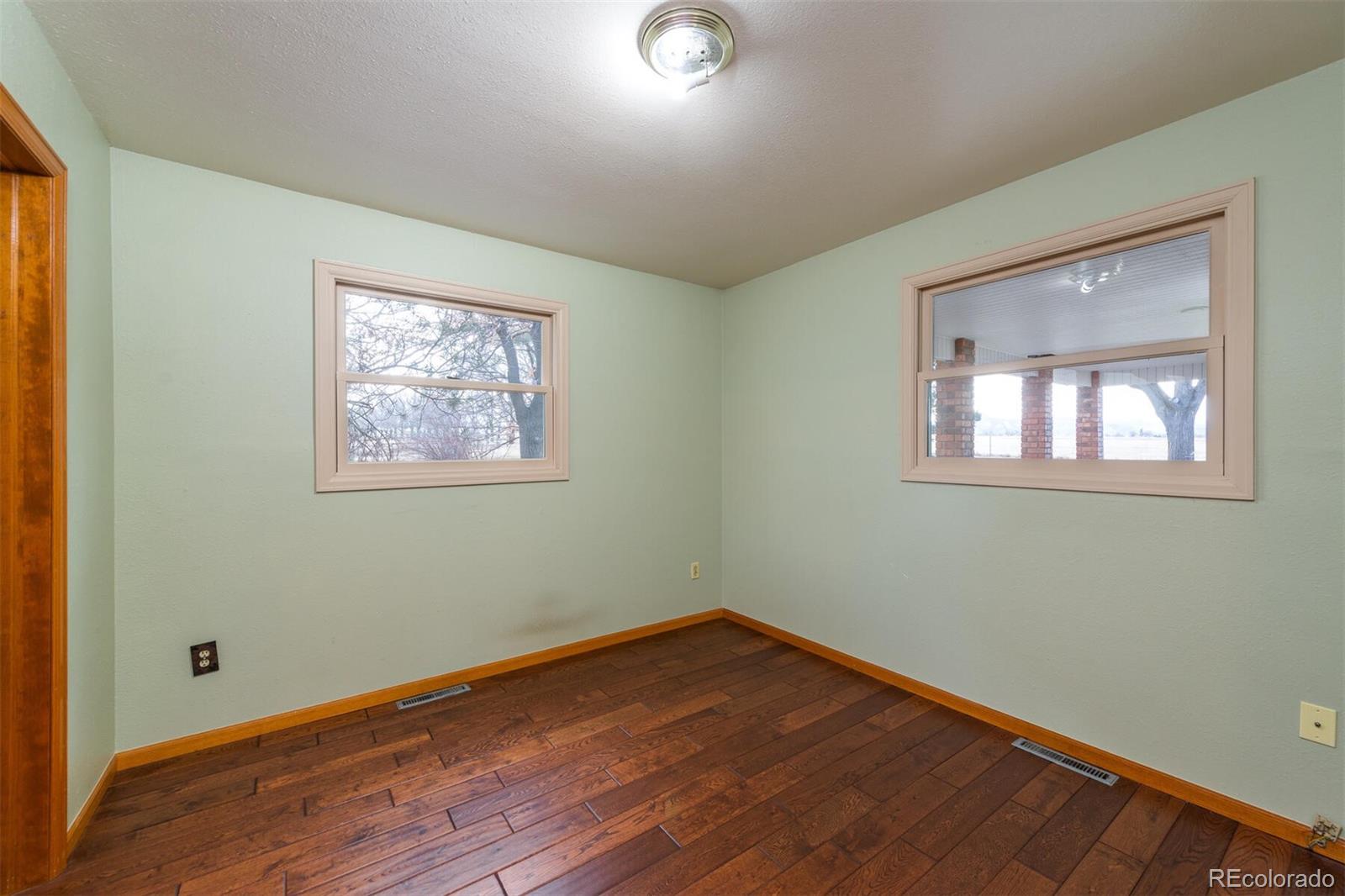 9905 Isabelle Road Lafayette, CO 80026 - Photo 31 of 38 a view of empty room with wooden floor and fan