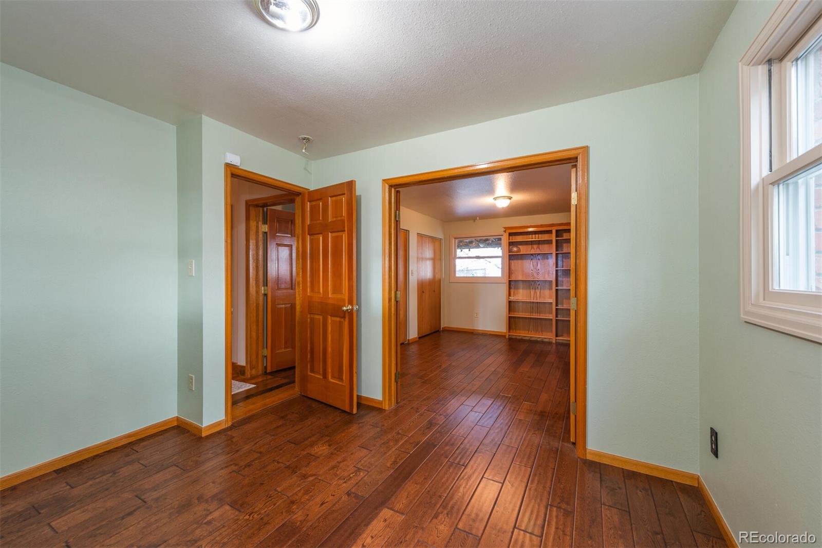 9905 Isabelle Road Lafayette, CO 80026 - Photo 32 of 38 an empty room with wooden floor and windows