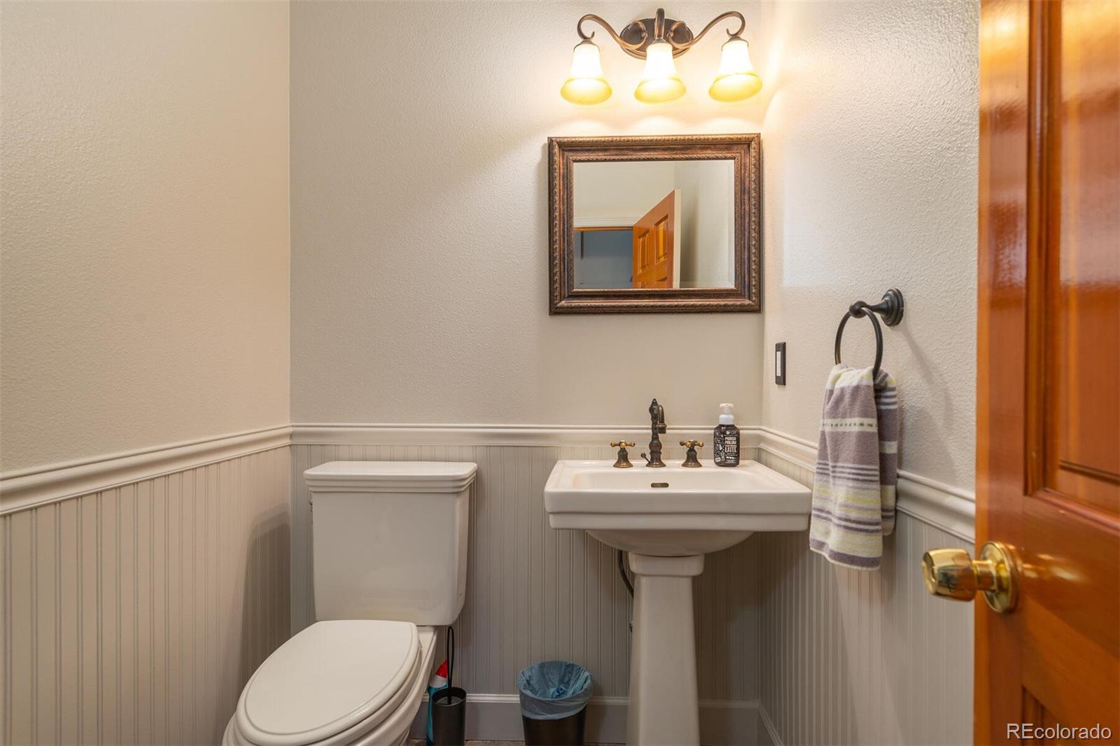 9905 Isabelle Road Lafayette, CO 80026 - Photo 35 of 38 a bathroom with a sink mirror and toilet