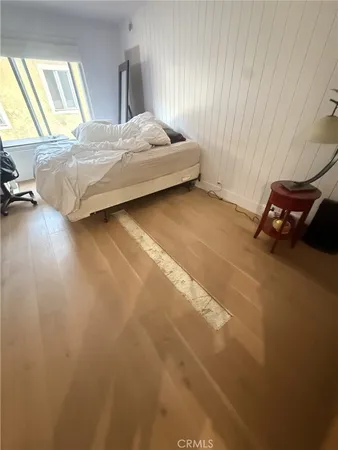 a bedroom with a bed and a night stand