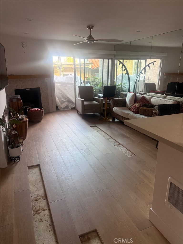 8740 Tuscany Avenue, Unit 211 Playa del Rey, CA 90293 - Photo 16 of 24 a living room with furniture and a large window