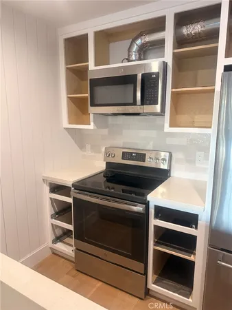 a kitchen with a stove and a microwave