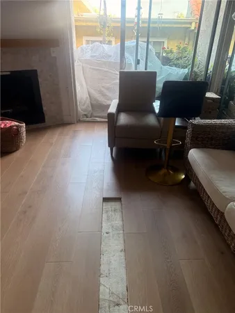a living room with furniture and a floor to ceiling window