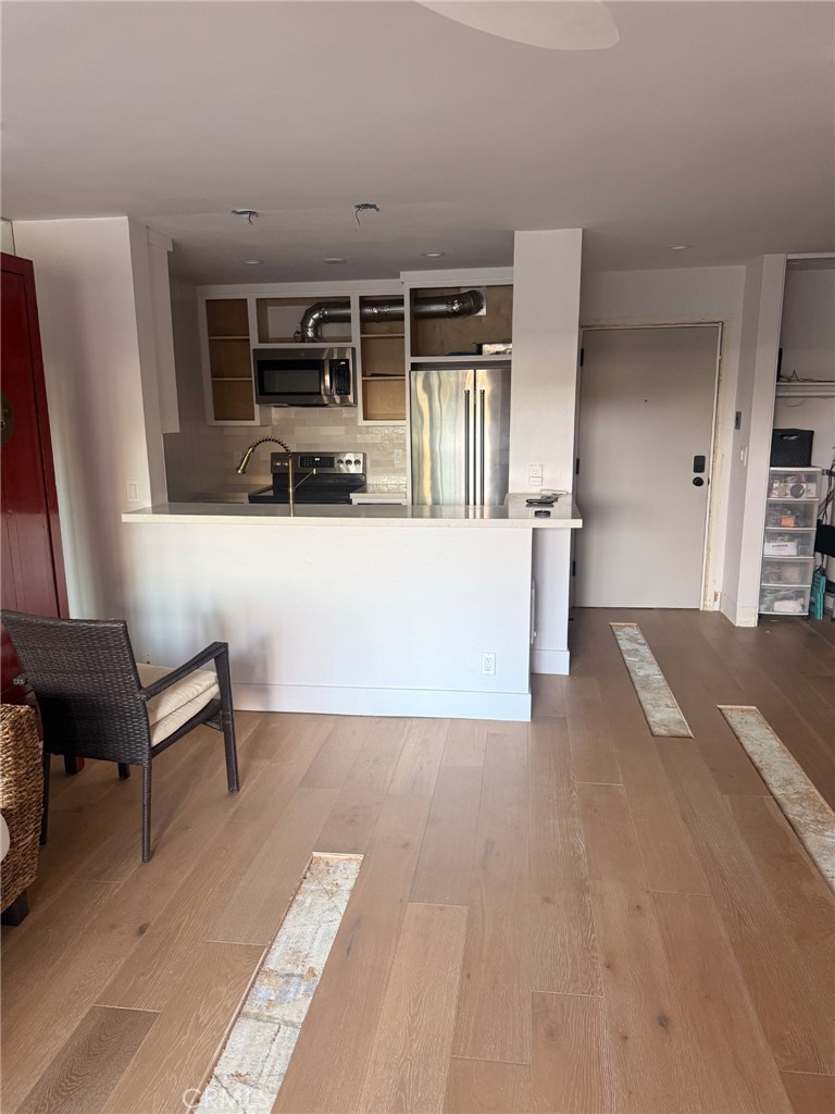 8740 Tuscany Avenue, Unit 211 Playa del Rey, CA 90293 - Photo 4 of 24 a view of kitchen with furniture and wooden floor