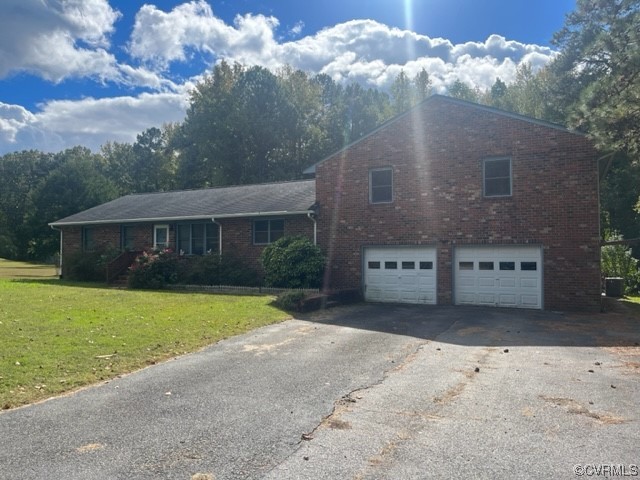 5711 Thweatt Drive Disputanta, VA 23842 - Photo 19 of 19 a view of a house with a yard and garage