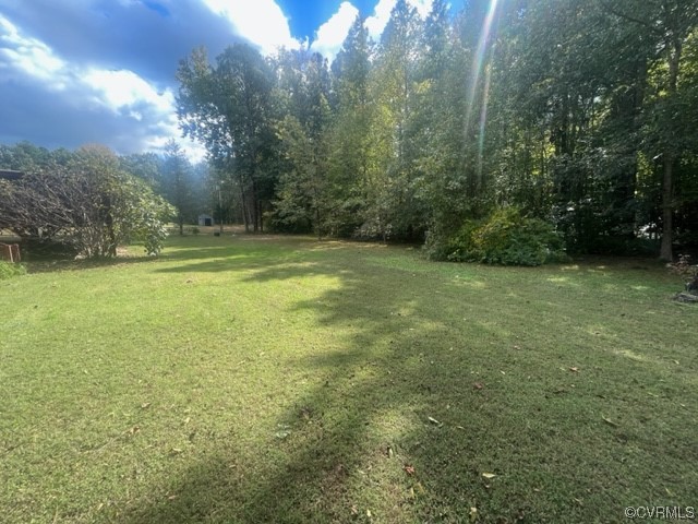 5711 Thweatt Drive Disputanta, VA 23842 - Photo 2 of 19 a view of a green yard with large trees