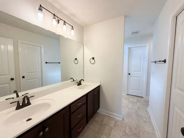 a bathroom with a double vanity sink mirror and double