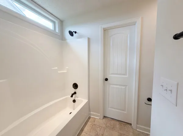 a bathroom with a bathtub and shower