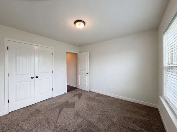 a view of an empty room and a window