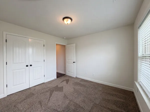 a view of an empty room and a window
