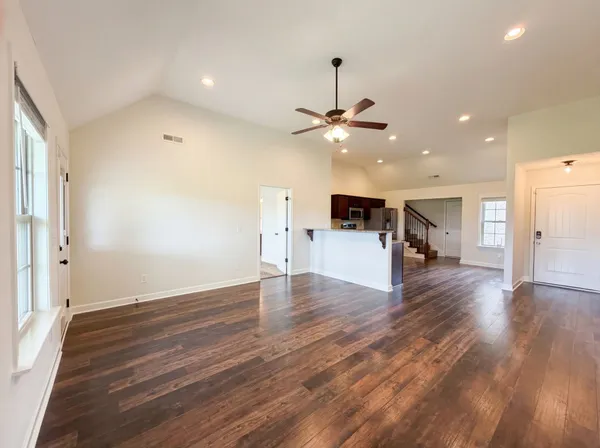 a view of empty room with wooden floor